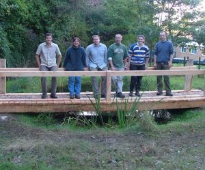 Volunteers and rangers with a bridge they built